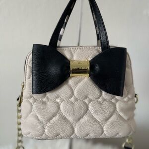 Black and cream Betsey Johnson crossbody/two handle purse w/matching wallet.
